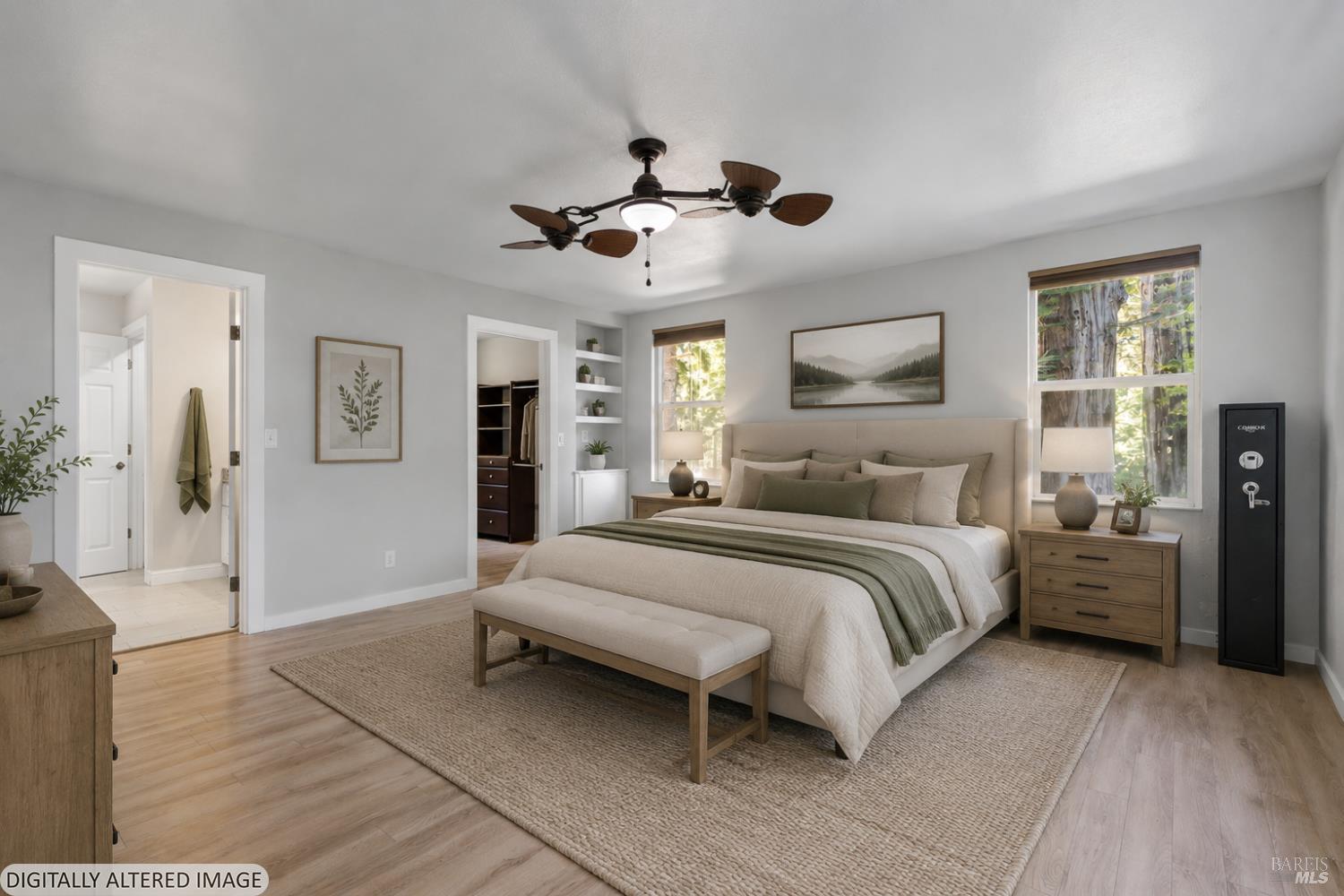 44000 Iversen Road Gualala, CA 95445 - Photo 18 of 64 a bedroom with a large bed and a chandelier