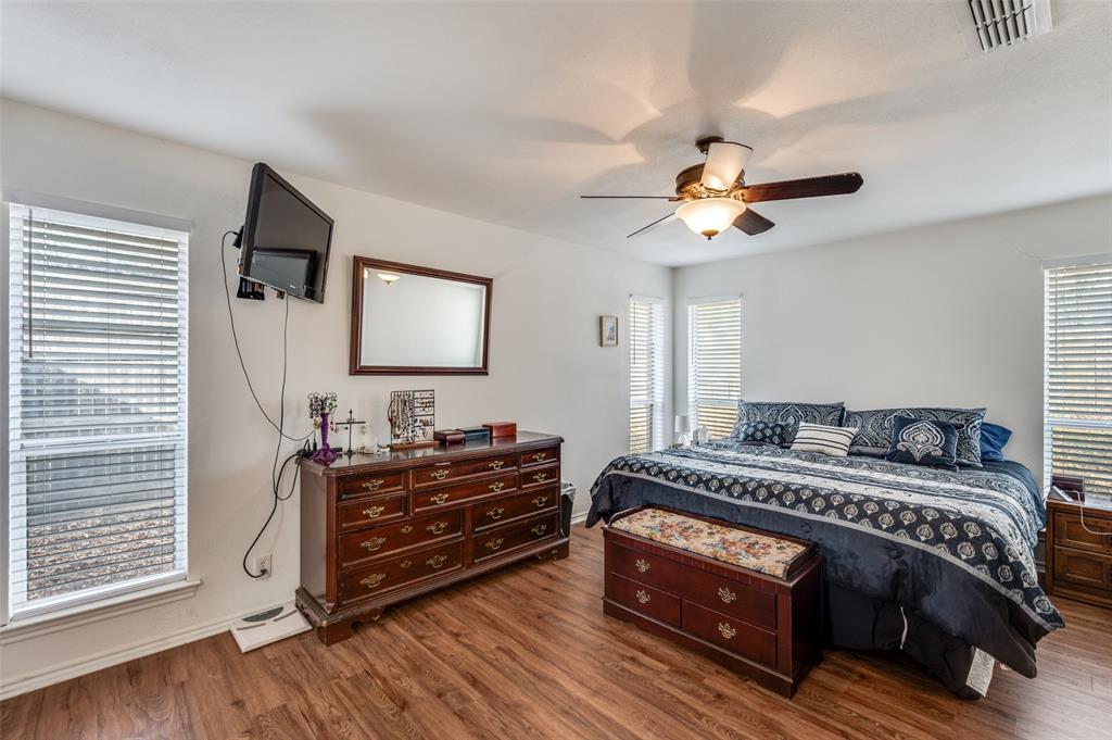 1509 Springbrook Street Corinth, TX 76210 - Photo 12 of 24 a bedroom with a bed and a chandelier