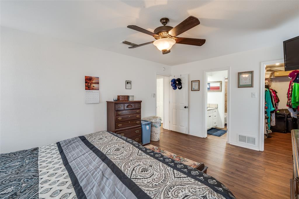 1509 Springbrook Street Corinth, TX 76210 - Photo 14 of 24 a view of a bedroom with furniture and wooden floor