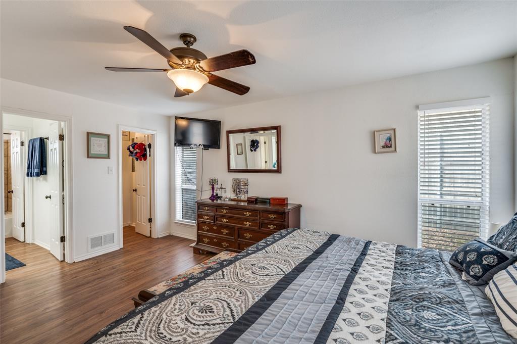 1509 Springbrook Street Corinth, TX 76210 - Photo 15 of 24 a bedroom with a bed and wooden floor