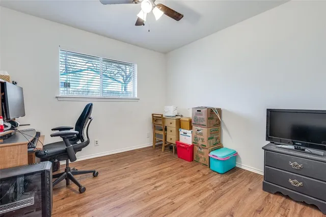 a view of a workspace with furniture and a flat screen tv