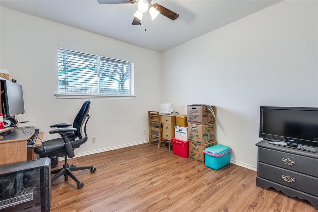 1509 Springbrook Street Corinth, TX 76210 - Photo 19 of 24 a view of a workspace with furniture and a flat screen tv