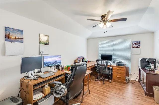 a view of a workspace with furniture and a flat screen tv
