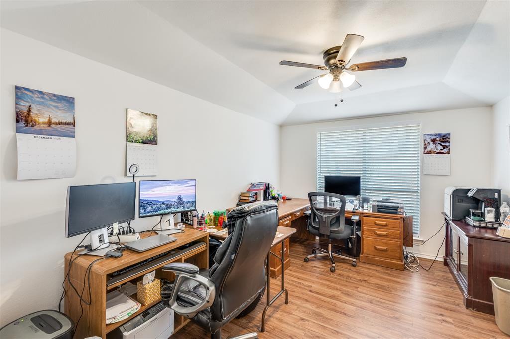 1509 Springbrook Street Corinth, TX 76210 - Photo 20 of 24 a view of a workspace with furniture and a flat screen tv