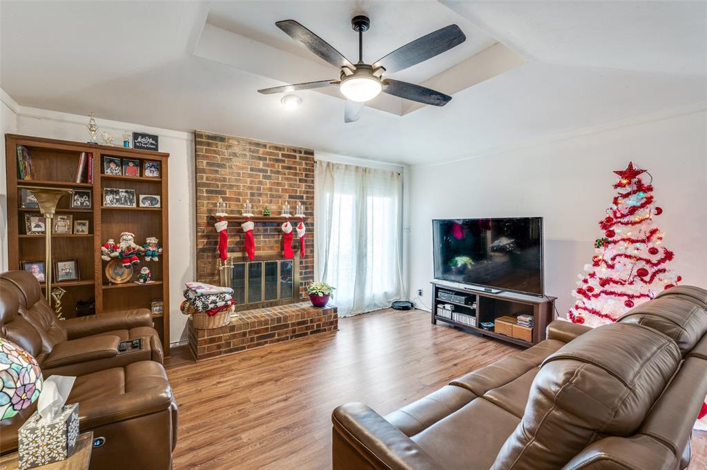 1509 Springbrook Street Corinth, TX 76210 - Photo 2 of 24 a living room with furniture and a flat screen tv