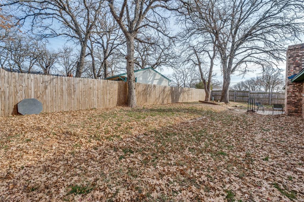 1509 Springbrook Street Corinth, TX 76210 - Photo 22 of 24 a front view of a house with a yard