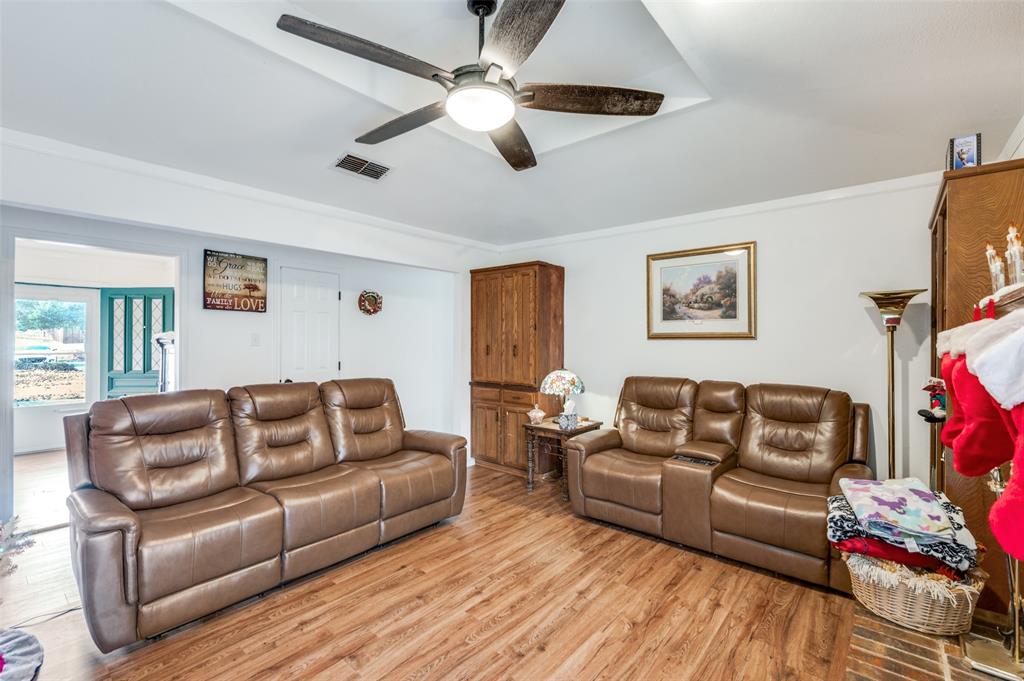 1509 Springbrook Street Corinth, TX 76210 - Photo 3 of 24 a living room with furniture and a wooden floor