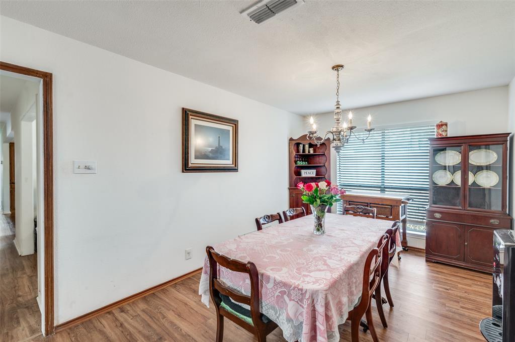 1509 Springbrook Street Corinth, TX 76210 - Photo 7 of 24 a view of a dining room with furniture window and wooden floor