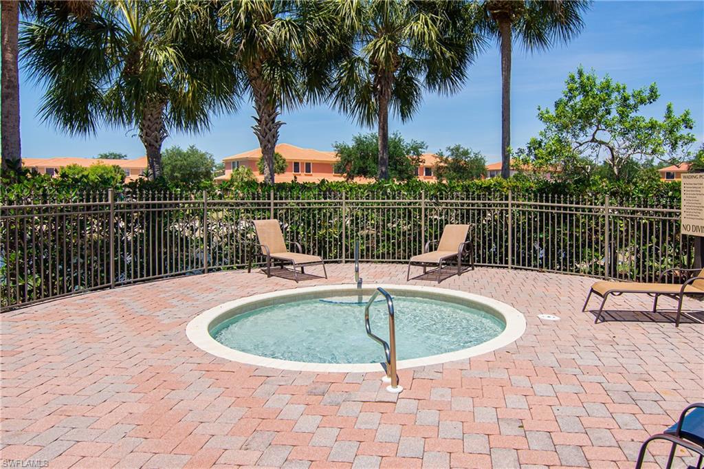 15186 Summit Pl Circle Naples, FL 34119 - Photo 13 of 37 a view of a swimming pool with a lake view and a garden