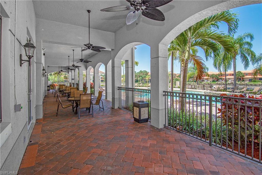 15186 Summit Pl Circle Naples, FL 34119 - Photo 14 of 37 View of patio / terrace featuring outdoor dining area, a community pool, and a ceiling fan