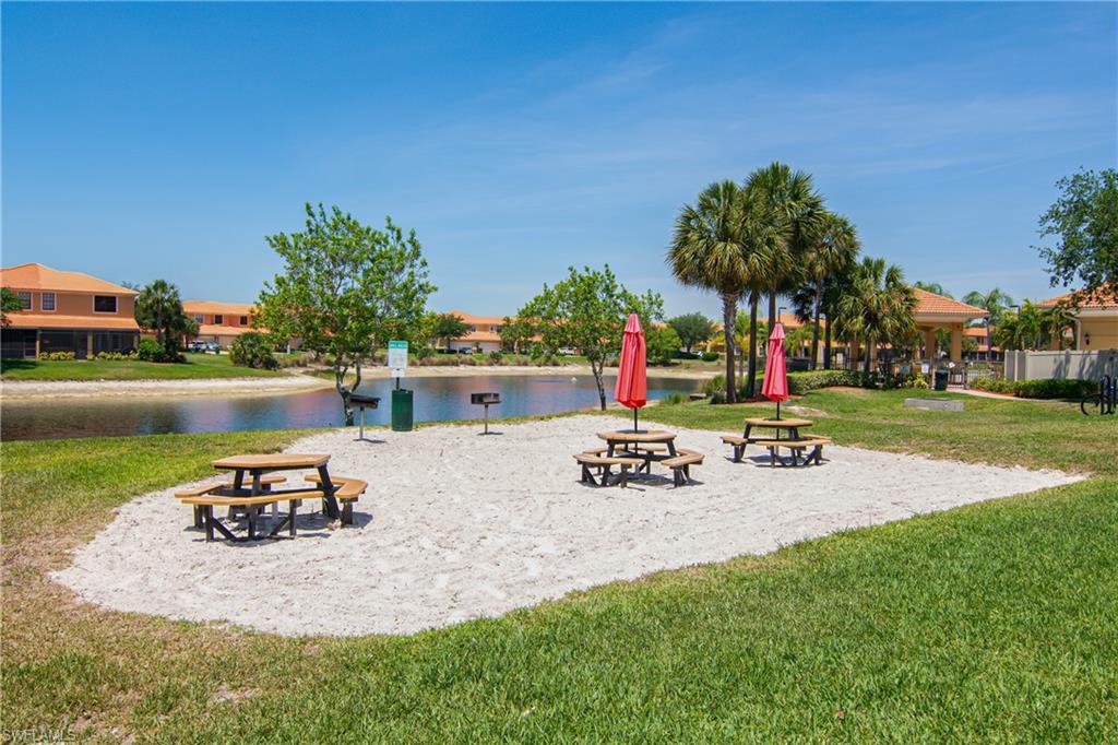 15186 Summit Pl Circle Naples, FL 34119 - Photo 15 of 37 a view of a backyard with a patio and outdoor seating