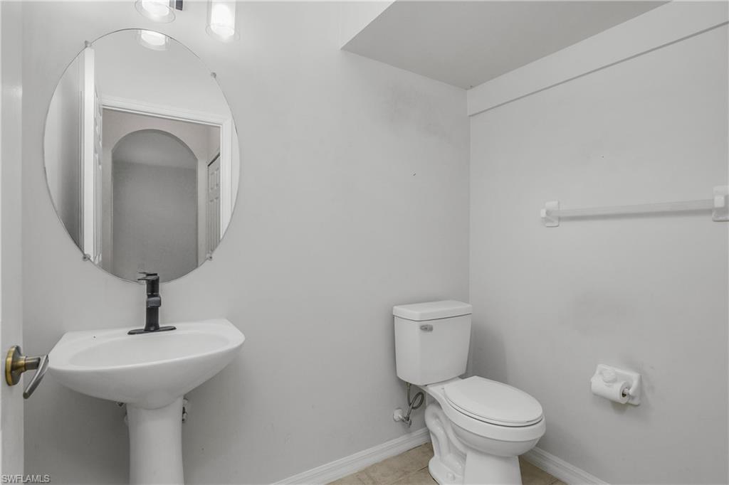 15186 Summit Pl Circle Naples, FL 34119 - Photo 20 of 37 Bathroom featuring toilet and light tile patterned floors