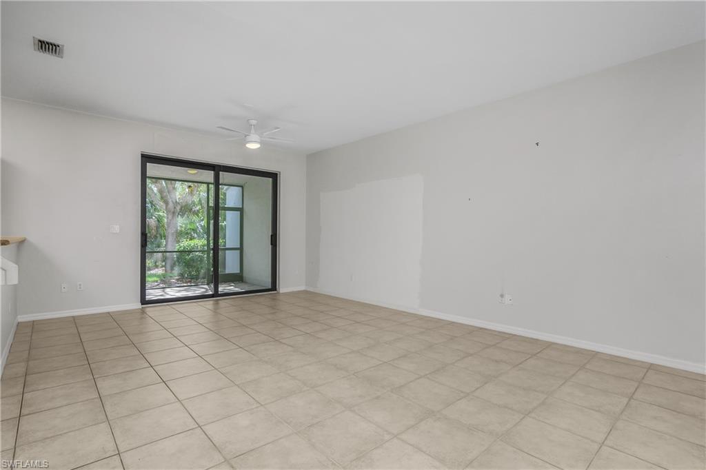 15186 Summit Pl Circle Naples, FL 34119 - Photo 23 of 37 an empty room with windows