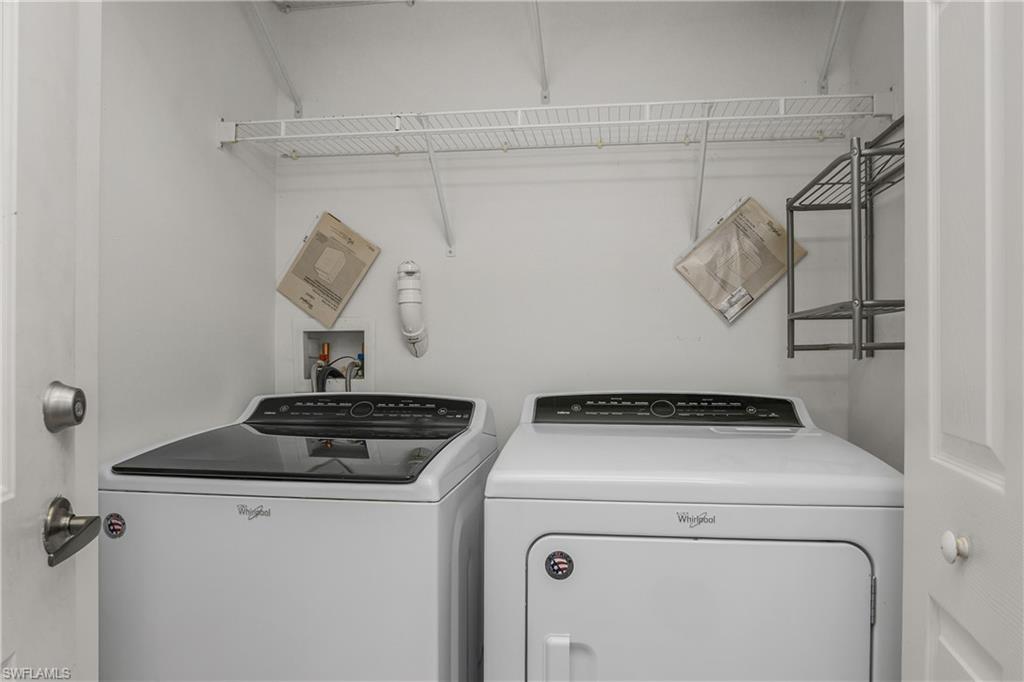 15186 Summit Pl Circle Naples, FL 34119 - Photo 28 of 37 a view of storage and utility room with racks on the wall