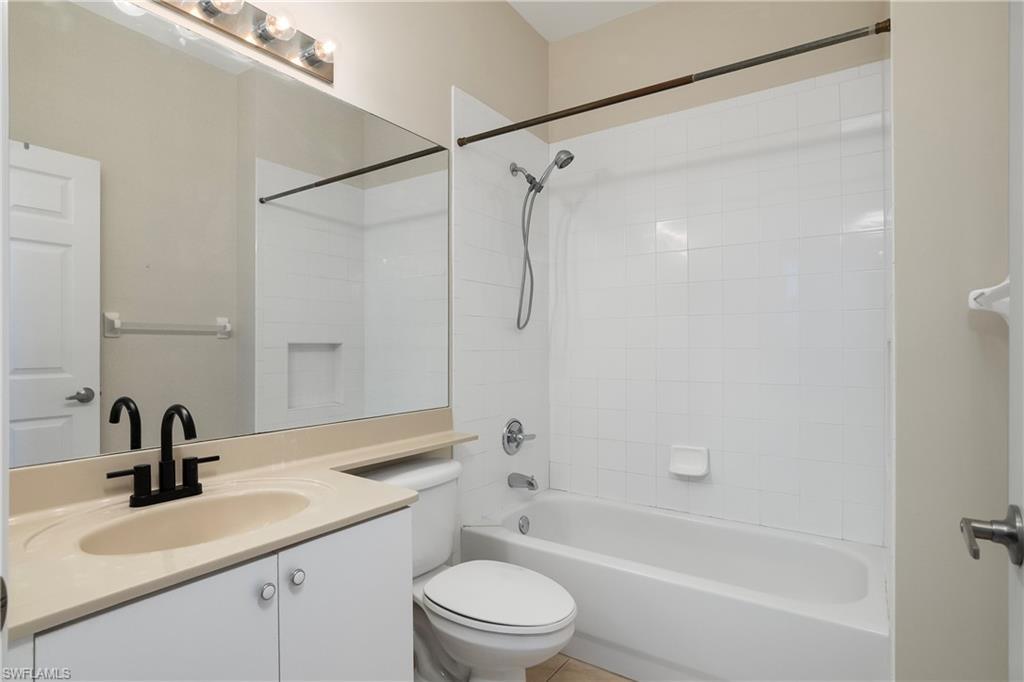 15186 Summit Pl Circle Naples, FL 34119 - Photo 33 of 37 a bathroom with a sink a toilet and a bathtub