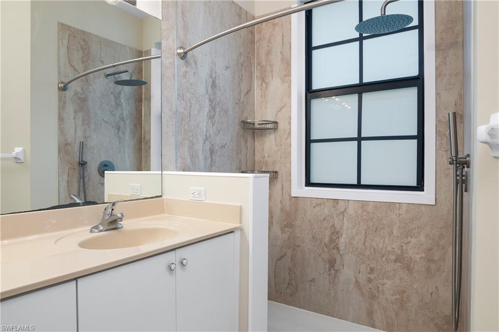 15186 Summit Pl Circle Naples, FL 34119 - Photo 36 of 37 a bathroom with a sink and a mirror