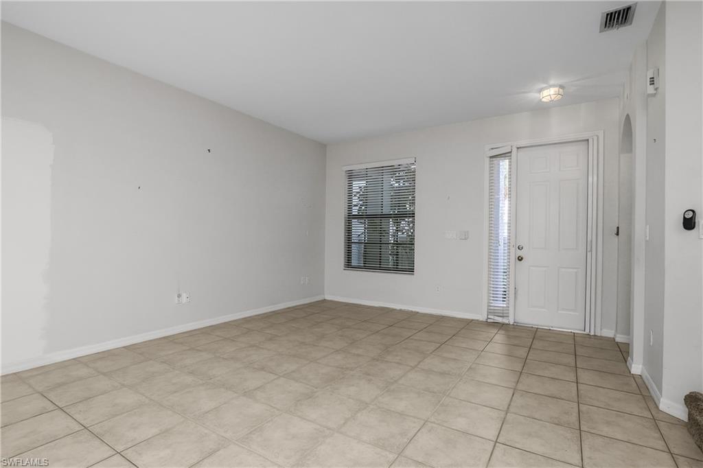 15186 Summit Pl Circle Naples, FL 34119 - Photo 4 of 37 a view of an empty room with a window