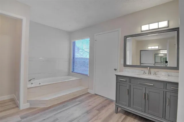 a bathroom with a double vanity sink and mirror with shower