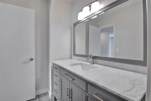 a bathroom with a sink and a mirror