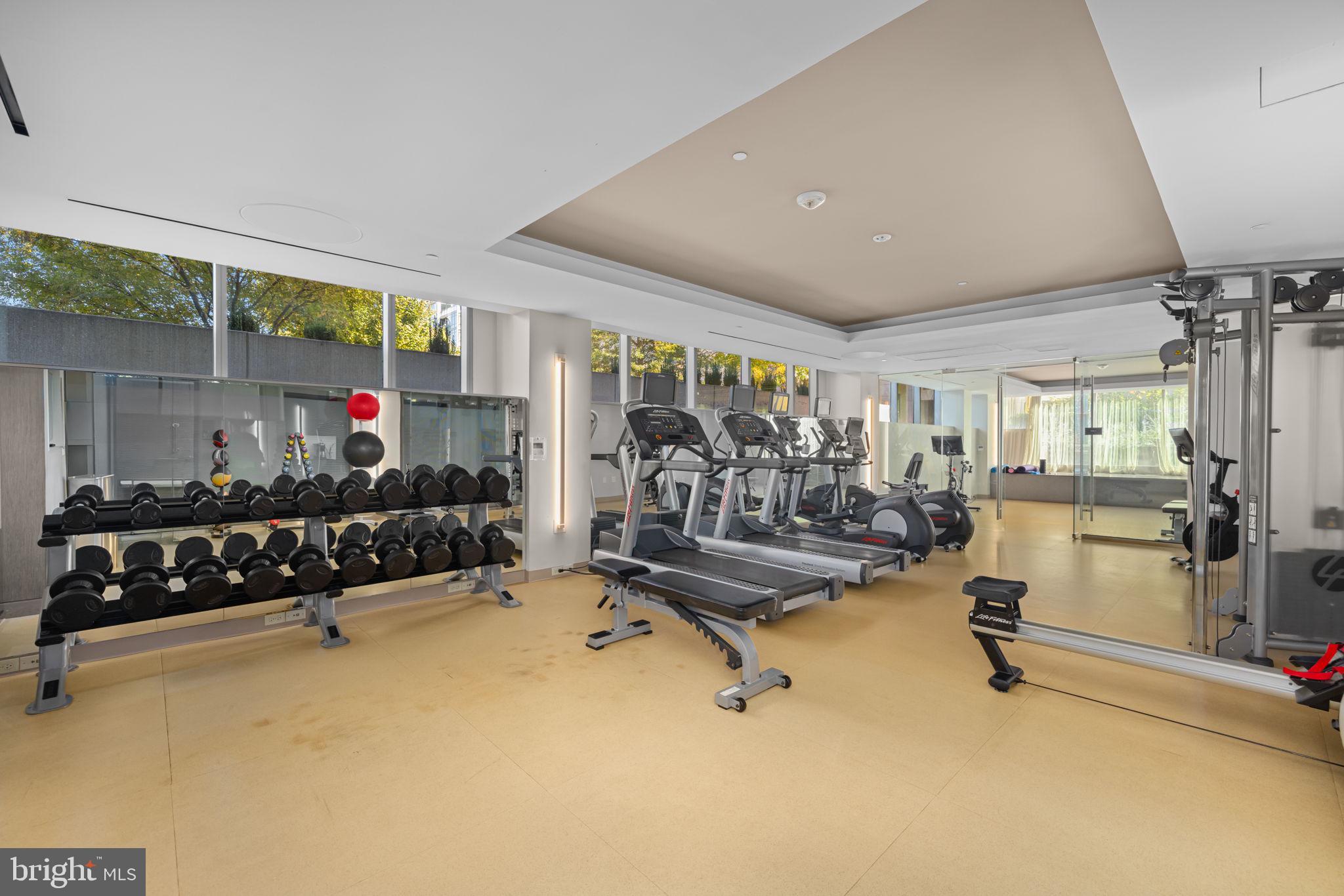 2501 M Street Northwest, Unit T04 Washington, DC 20037 - Photo 25 of 29 a living room with furniture gym equipment and a large window