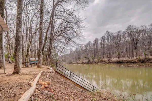 a view of a yard with wooden fence