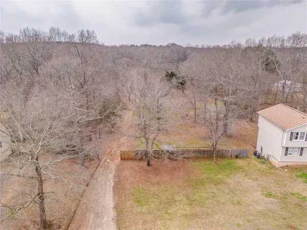a view of roof with wooden floor and fence
