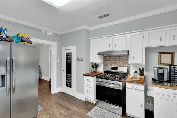 a kitchen with stainless steel appliances a refrigerator sink and cabinets