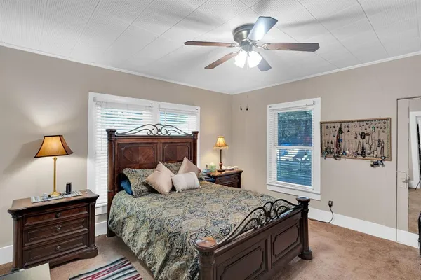 a bedroom with a bed and window