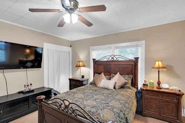 a bedroom with a bed and a flat screen tv