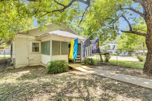 a backyard of a house with table and chairs