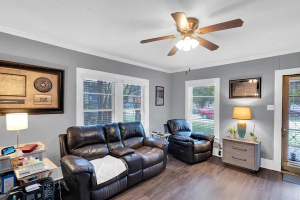 a living room with furniture and wooden floor