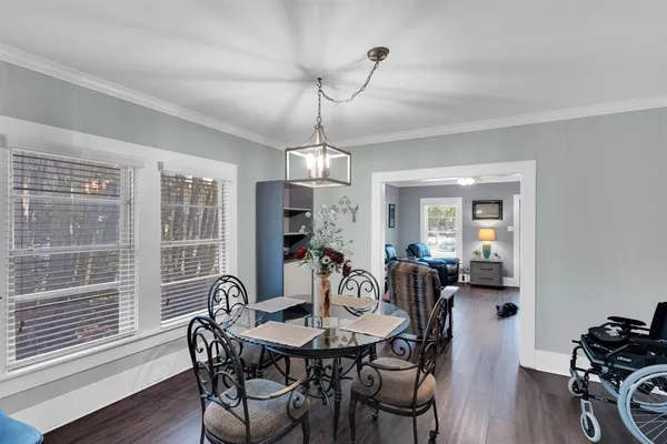a view of a dining room with furniture window and wooden floor