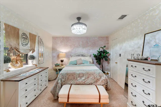 a bedroom with a bed and a dresser