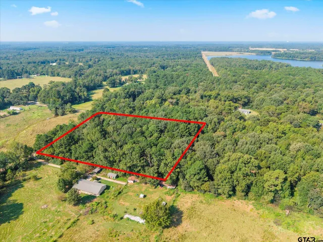 an aerial view of a houses with a yard