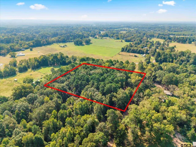 an aerial view of residential houses with outdoor space and swimming pool