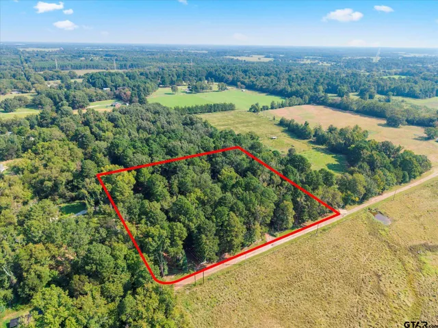 an aerial view of lake and residential houses with outdoor space
