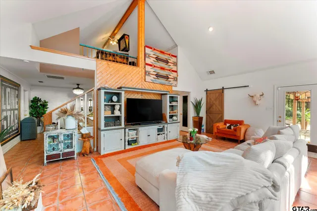 a bedroom with furniture and a flat screen tv