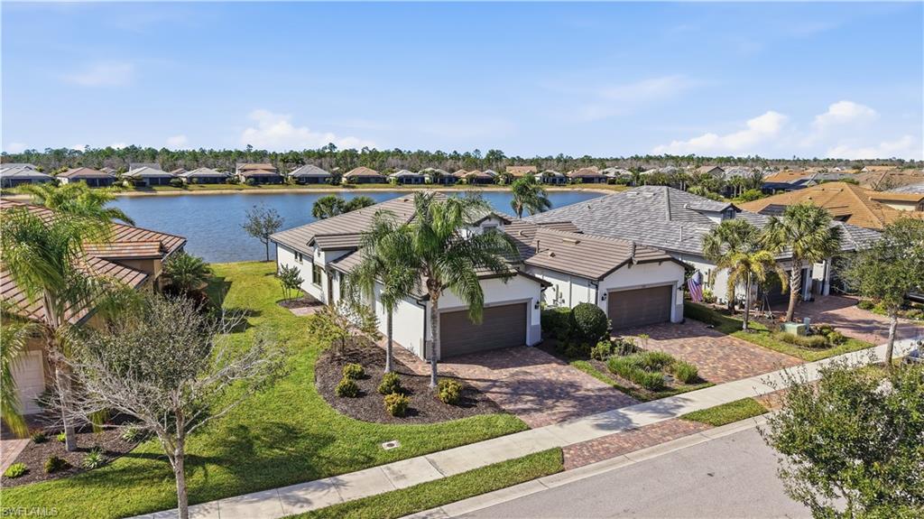 7733 Jacaranda Lane Naples, FL 34114 - Photo 1 of 38 an aerial view of a house with a yard and lake view