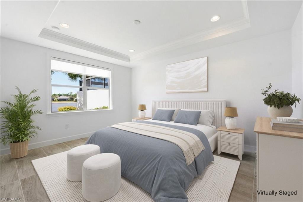 7733 Jacaranda Lane Naples, FL 34114 - Photo 12 of 38 a bedroom with a bed and a potted plant