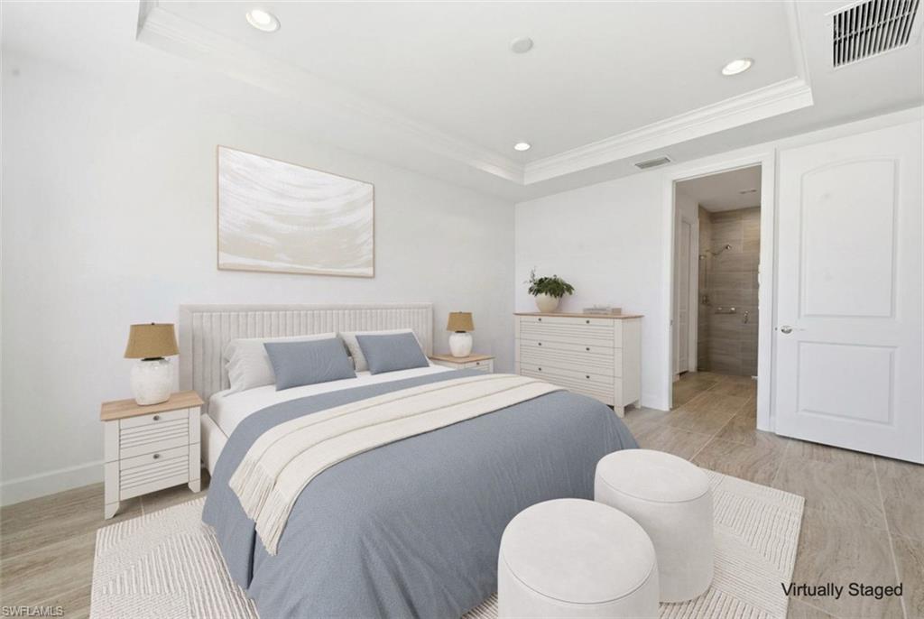 7733 Jacaranda Lane Naples, FL 34114 - Photo 13 of 38 a bedroom with a bed and a couch