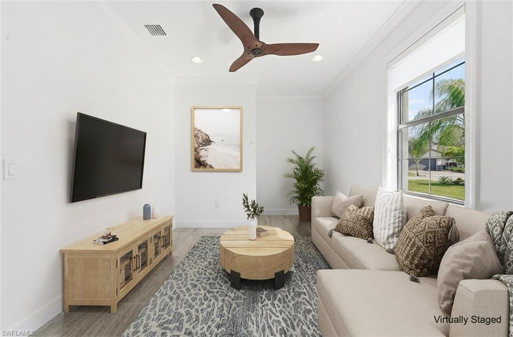 7733 Jacaranda Lane Naples, FL 34114 - Photo 17 of 38 a living room with furniture and a flat screen tv