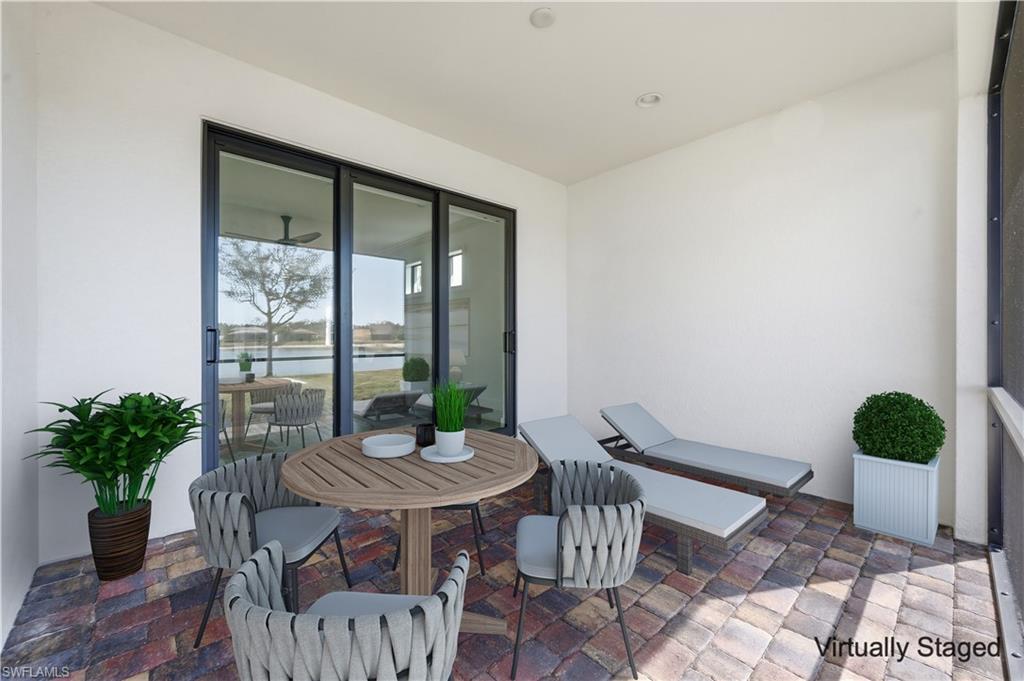 7733 Jacaranda Lane Naples, FL 34114 - Photo 21 of 38 a table and chairs in a room