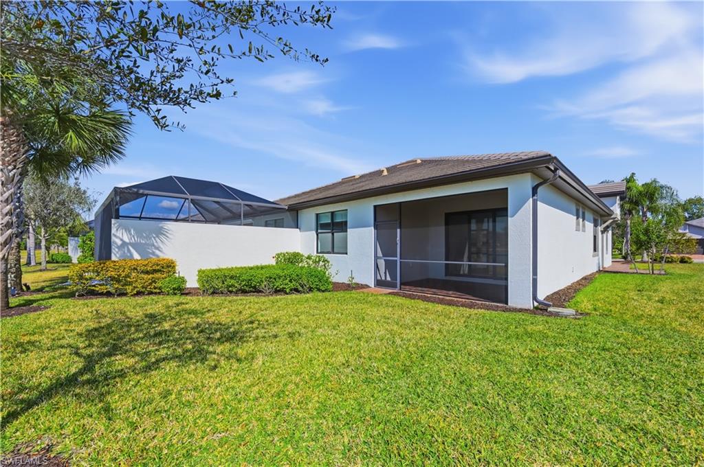 7733 Jacaranda Lane Naples, FL 34114 - Photo 23 of 38 a view of a house with a yard