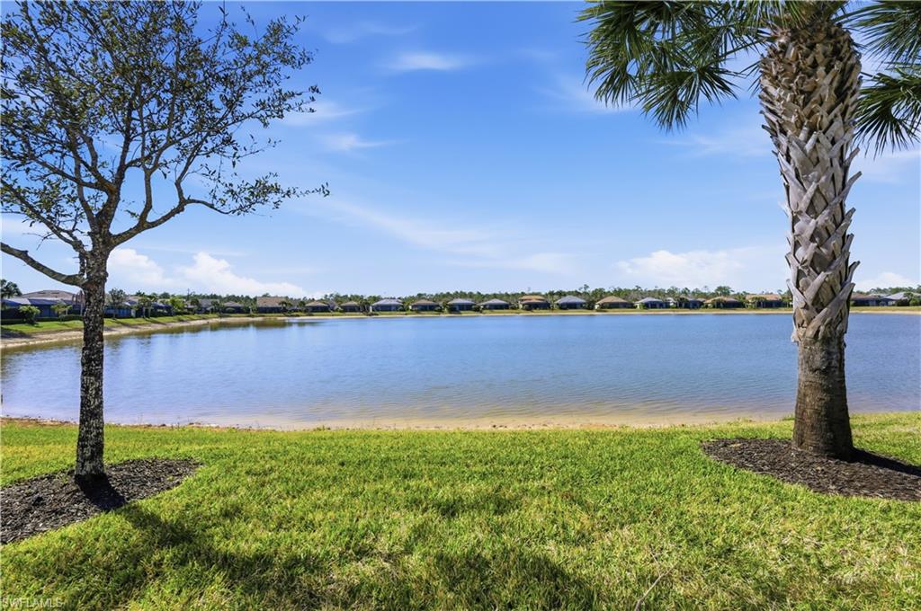 7733 Jacaranda Lane Naples, FL 34114 - Photo 26 of 38 a view of a lake from a yard