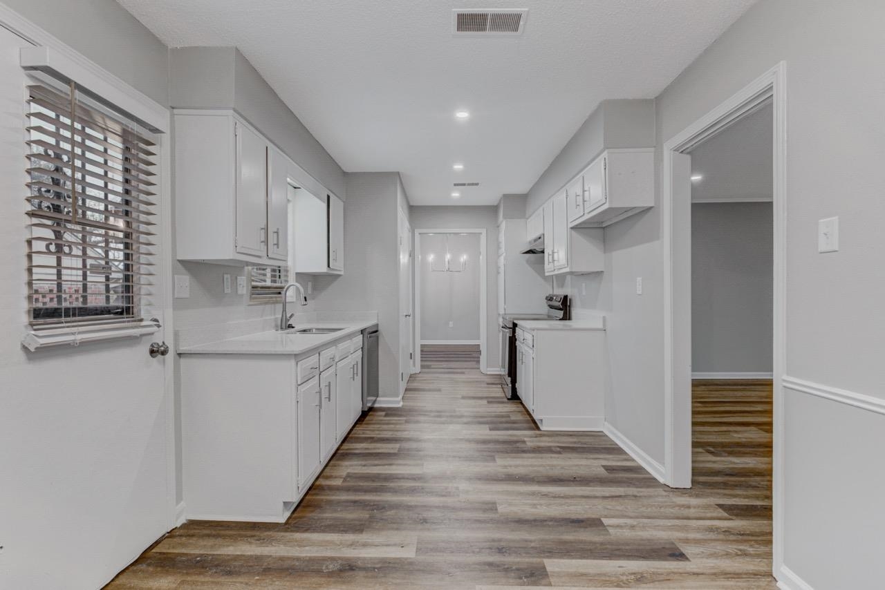 3187 Belle Tower Road Memphis, TN 38115 - Photo 12 of 24 Kitchen featuring white cabinetry, stainless steel appliances, light wood-style floors, and recessed lighting