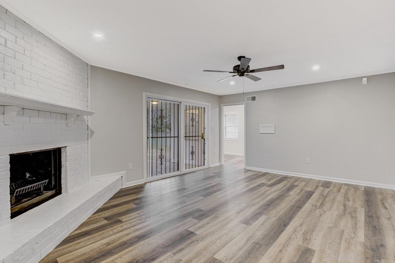 3187 Belle Tower Road Memphis, TN 38115 - Photo 14 of 24 Unfurnished living room with a fireplace, recessed lighting, light wood finished floors, and a ceiling fan