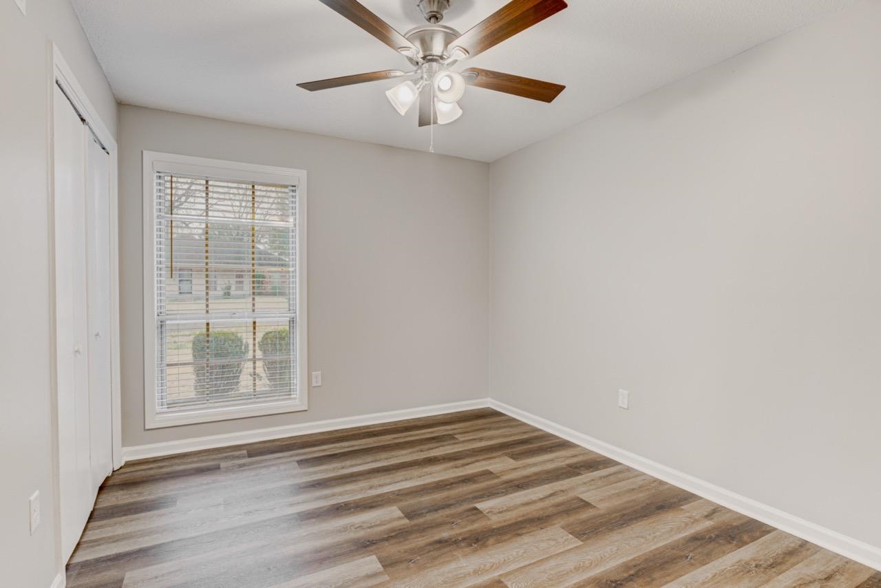 3187 Belle Tower Road Memphis, TN 38115 - Photo 15 of 24 Unfurnished bedroom featuring a closet, wood finished floors, and ceiling fan