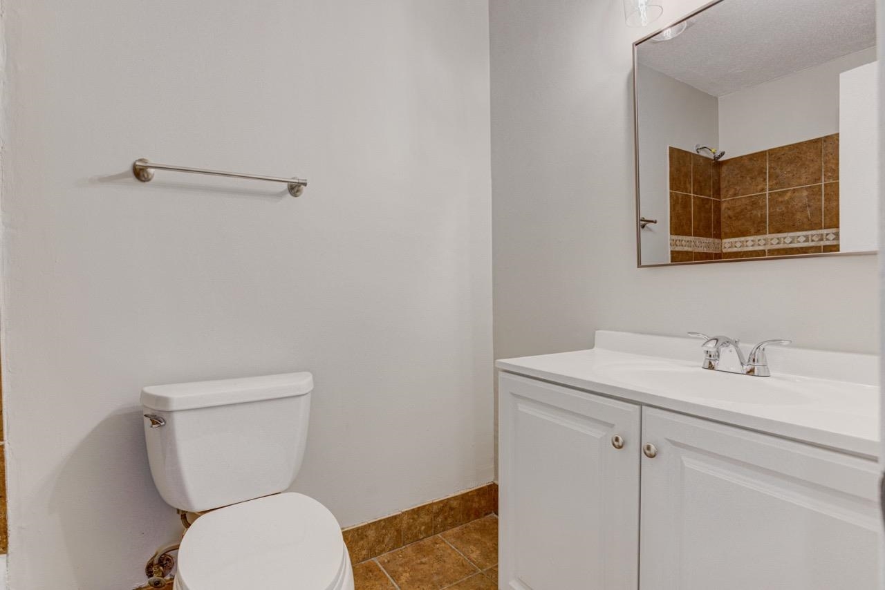3187 Belle Tower Road Memphis, TN 38115 - Photo 17 of 24 Bathroom featuring vanity, a shower, and tile patterned flooring