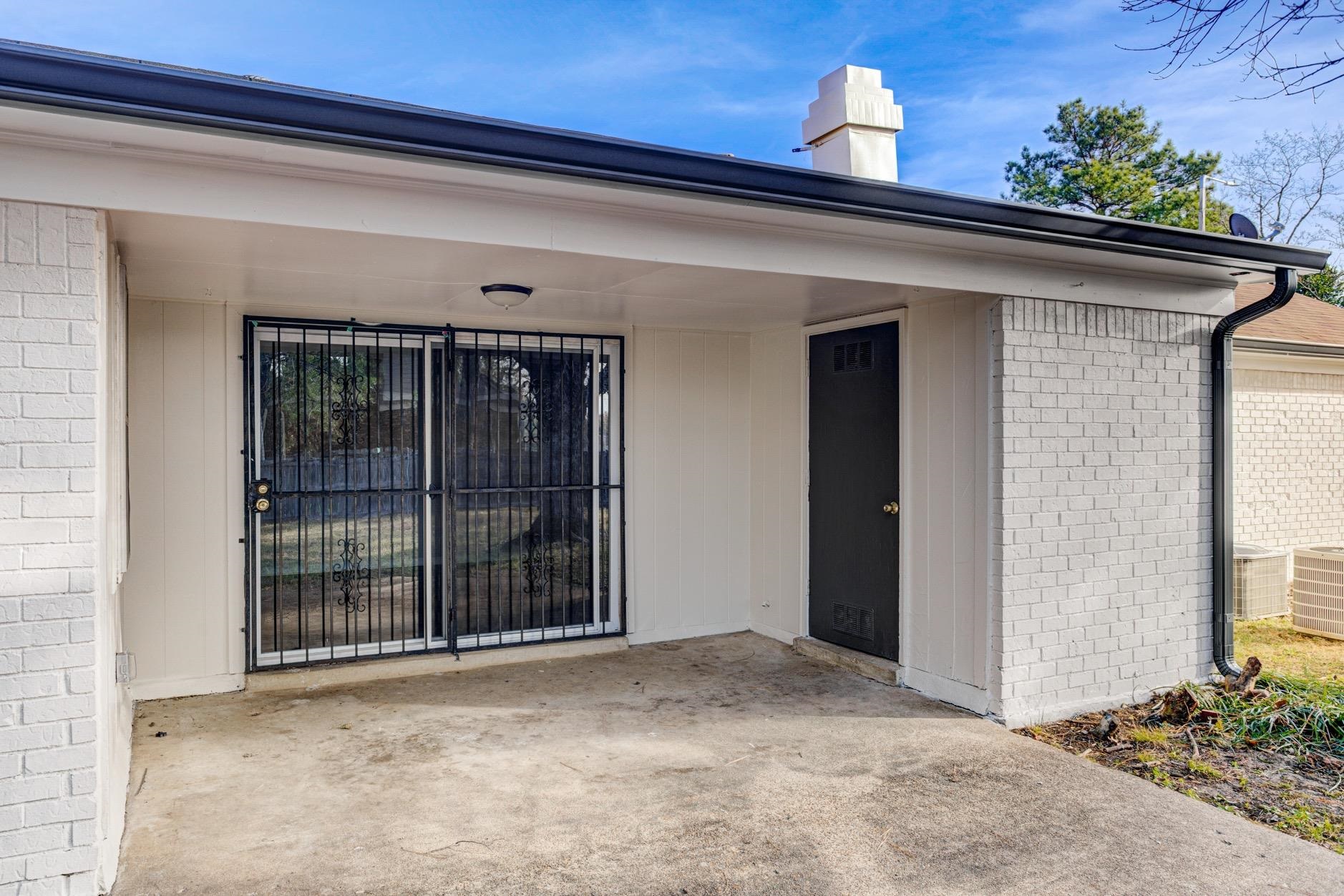 3187 Belle Tower Road Memphis, TN 38115 - Photo 23 of 24 Property entrance featuring a patio, brick siding, and a chimney