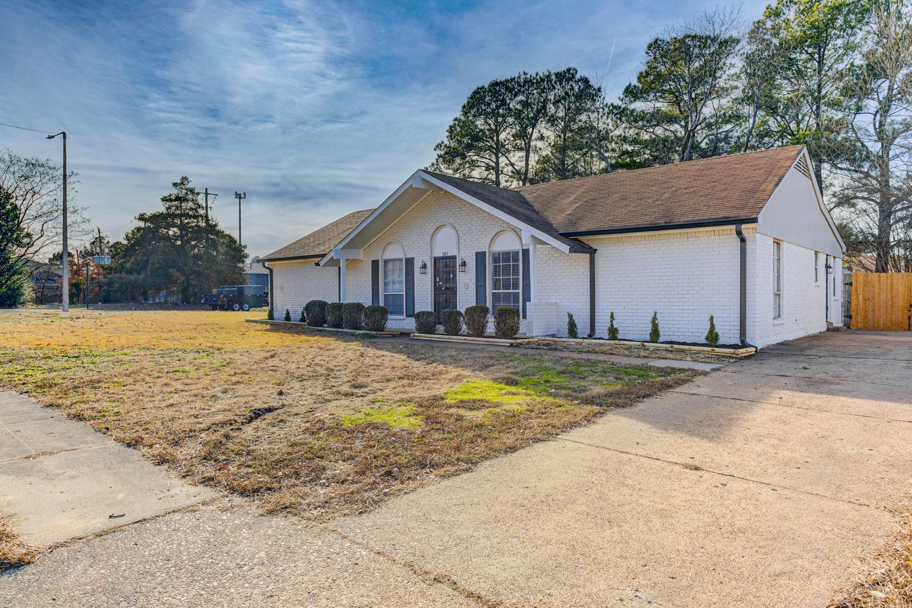 3187 Belle Tower Road Memphis, TN 38115 - Photo 5 of 24 Ranch-style home with brick siding and concrete driveway